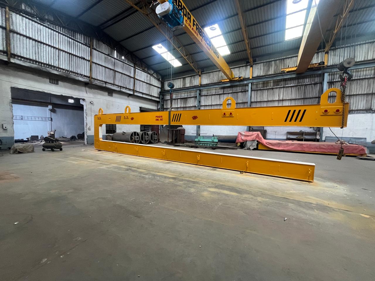 Pipe bundle hook suspended from the shop crane, PRAGYA SWL 15 T on the top beam